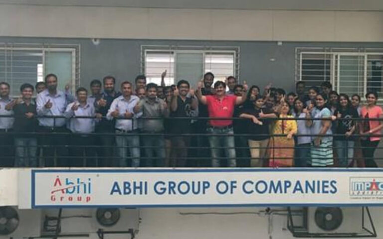 Businessman Jitendra Joshi getting picture clicked with his employees
